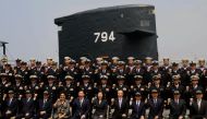 Taiwan President Tsai Ing-wen (C front row) poses for photos with navy servicemen in front of a Duch-made Sea Tiger submarine at the Tsoying navy base in Kaohsiung, southern Taiwan on March 21, 2017.   AFP / SAM YEH
