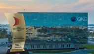 (Combo) for The Most Innovative Marketing Program Trophy with QNB head office building. © The Peninsula 