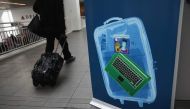 (FILES) This file photo taken on January 26, 2014 shows a traveler walking past a newly-opened TSA Pre-check application center at Terminal C of the LaGuardia Airport on Once approved, travelers can use special expidited Precheck security lanes.  AFP / JO