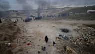 Displaced Iraqis, who fled their homes, warm themselves during a battle between Iraqi forces and Islamic State militants, near Badush, Iraq. REUTERS/Stringer REUTERS.