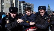 Police officers detain a man as opposition supporters gather for an unauthorised anti-corruption rally in central Moscow on March 26, 2017.   AFP / Vasily MAXIMOV
