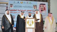 Dr Ayed bin Dabssan Al Qahtani, Chairman, Board of Trustees, and General Director, RAF, receiving the award from Sheikh Salman bin Abdullah bin Hamad Al Khalifa, Honorary President of Al Sanabel Orphans Care Society, Bahrain, and Dr Abdullatif bin Rashid 