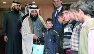 Dr Ayed bin Dabssan Al Qahtani, Chairman, Board of Trustees and General Director, RAF, handing over a bag of textbooks to a Syrian child in Turkey.