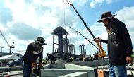 Workers assemble steel for one of the pavilions surrounding the late Thai king Bhumibol Adulyadej's funeral pyre in front of the Grand Palace in Bangkok, yesterday.