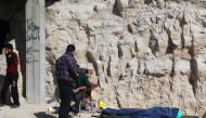 People stand near a dead body, after what rescue workers described as a suspected gas attack in the town of Khan Sheikhoun in rebel-held Idlib, Syria April 4, 2017. REUTERS/Ammar Abdullah.