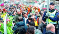 People gather at a makeshift memorial near the scene Ahlens in Stockholm, , yesterday.