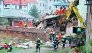Rescuers search after a building collapsed burying several people in Swiebodzice, yesterday.