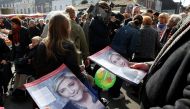 Supporters of French far right National Front political party leader Marine Le Pen distribute political leaflets as part of the 2017 French presidential election at a local market in Henin-Beaumont, France, April 7, 2017. Picture taken, April 7, 2017. Reu
