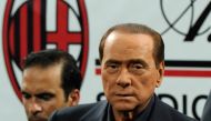 (FILES) This file photo taken on August 21, 2011 shows Italian President of Council Silvio Berlusconi steping on the pitch after AC MIlan won the Trophee Luigi Berlusconi match AC Milan against Juventus, 2-1, on August 21, 2011, in San Siro stadium in Mil