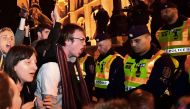 Young students shout an anti-government slogan in front of a police-line during a demonstration against Hungarian Prime Minister Viktor Orban's government in front of the parliament building on April 12, 2017 in Budapest. Thousands of Hungarians joined fr