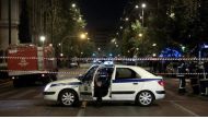 Greek police secure the area after a bomb blast in central Athens. / Reuters.