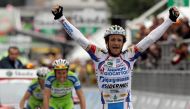 Androni-Diquigiova team rider Michele Scarponi of Italy celebrates his victory as he crosses the finish line ahead of Liquigas team riders Ivan Basso (C) and Vincenzo Nibali, both of Italy, during the 195-km 19th stage of the Giro d'Italia cycling race fr