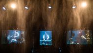 Members of the Between Music band perform with custom-made instruments in glass water tanks (AFP Photo/Jonathan Nackstrand)