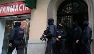 Spanish police stand guard outside an apartment building during a sweeping operation at some 12 locations against Islamist militants, in which eight people were arrested, in Barcelona, Spain, April 25, 2017. REUTERS/Albert Gea.