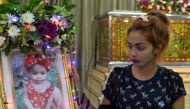 Jiranuch Trirat, mother of 11-month-old daughter who was killed by her father who broadcast the murder on Facebook, stands next to a picture of her daughter at a temple in Phuket, Thailand April 25, 2017. — Reuters pic.
