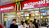 (FILES) This file photo taken on February 15, 2003 shows people walking past a McDonald's restarant in downtown Tokyo.  AFP / Yoshikazu TSUNO
