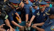 FILE PHOTO: Philippine National Police Director General Ronald Dela Rosa along with other officials dunks confiscated illegal firecrackers into a tub of water to render them unusable, December 29, 2016 (REUTERS / Ezra Acayan) 