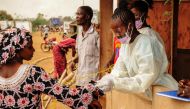 FILE PHOTO: Sierra Leone officials checking passengers transiting at the border crossing with Liberia in Jendema to curb the spread of Ebola, March 26, 2015. AFP / Zoom Dosso