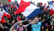 Supporters of French President Elect Emmanuel Macron celebrate near the Louvre museum after early results were announced in the second round vote in the 2017 presidential elections in Paris, France, May 7, 2017. REUTERS/Christian Hartmann