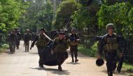File Photo: Troops carrying dead bodies last week after a military operation against Abu Sayyaf in the southern Philippine province of Sulu. Credit Nickee Butlangan/Reuters.