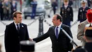 Outgoing French President Francois Hollande (R) and President-elect Emmanuel Macron attend a ceremony to mark the end of World War II at the Tomb of the Unknown Soldier at the Arc de Triomphe in Paris, France, May 8, 2017. REUTERS/Philippe Wojazer