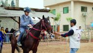 A boy learns horse riding in Gaza.