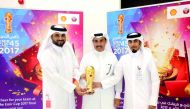 Officials with the Emir Cup. 