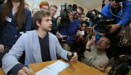 Ruslan Sokolovsky (L), a blogger who played Pokemon Go on his phone in a church, speaks to the press during a hearing at a court in Yekaterinburg on May 11, 2017. A Russian court on May 11 convicted a video blogger of inciting hatred against believers by 