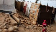 A girl from the Rohingya Muslim community walks past a makeshift settlement on the outskirts of Jammu, May 6, 2017. REUTERS/Mukesh Gupta