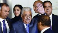 Palestine President Mahmoud Abbas waves as he walks with officials after arriving at Palam Air Force Station in New Delhi on May 14, 2017. Palestine President Mahmoud Abbas is on a four day state visit to India till May 17.  AFP / Prakash Singh