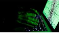 A man types on a computer keyboard in front of the displayed cyber code in this illustration picture taken on March 1, 2017. (Reuters).
