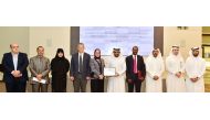 QU President Dr Hassan Al Derham, faculty members and officials with the accreditation certificate. 