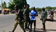 Mutinous soldiers prepare to leave the south entrance to Bouake on May 16, 2017. Rebel troops in Ivory Coast on May 16, 2017 said they were ending a four-day mutiny after coming to an agreement with the government over a pay dispute. / AFP / ISSOUF SANOGO