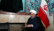 Iran's President Hassan Rouhani fills in his ballot as he votes during the presidential election in Tehran, Iran, May 19, 2017. President.ir/Handout via REUTERS
