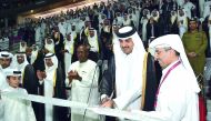 Emir H H Sheikh Tamim bin Hamad Al Thani cutting the ribbon to officially announce the inauguration of the refurbished Khalifa International Stadium, yesterday.