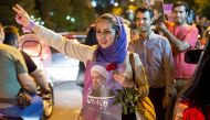 A woman holds a poster of Iranian President Hassan Rouhani during a campaign rally in Tehran, Iran, May 17, 2017. Picture taken May 17, 2017. TIMA via REUTERS