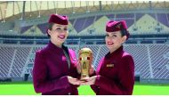 Qatar Airways hostesses display the Emir Cup trophy. 