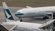 (FILES) In this file photo taken on March 15, 2017 a Cathay Pacific Boeing 777 passenger aircraft (top) taxis past a stationary plane on the tarmac at the international airport in Hong Kong. AFP / Anthony WALLACE