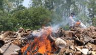 A Nepali park worker burns wildlife parts seized from poachers at Chitwan National Park, some 250 kms south of Kathmandu on May 22, 2017. AFP