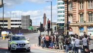 Members of the media gather at a police cordon close to the Manchester Arena in Manchester, northwest England on May 23, 2017 following a deadly terror attack at the Ariana Grande concert at the Manchester Arena the night before.  AFP / Oli SCARFF