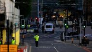 Police patrol the secure area outside the Manchester Arena in central Manchester, Britain
