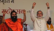  Narendra Modi and Indian yoga guru Baba Ramdev (L) raise their hands as they chant patriotic slogans during a Yoga Mahotsav or festival, in New Delhi March 23, 2014. REUTERS/Adnan Abidi