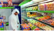 A municipal official inspecting fruits at an outlet. 