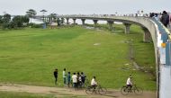 People gather by the Dhola-Sadiya bridge across the River Lohit, a tributary of the River Brahmaputra, which was inaugurated by Indian Prime Minister Narendra Modi in Assam on May 26, 2017. AFP / Biju Boro 