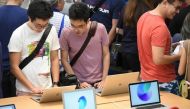 People look at products on display inside the Apple store in the Orchard shopping district on its opening day in Singapore on May 27, 2017. / AFP / Roslan RAHMAN.