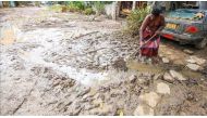A Sri Lankan flood victim cleans as the water level starts to decline in Wellampitiya, neighborhood of Colombo, Sri Lanka on May 25, 2016. ( Chamila Karunarathne - Anadolu Agency ).
