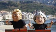 Protesters wear masks depicting U.S. President Donald Trump and Britain's Prime Minister Theresa May during a demonstration against a G7 summit organised by Oxfam in Giardini Naxos near Taormina, Sicily, Italy, May 27, 2017. (REUTERS/Yara Nardi)