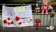 A banner, soft toys and flowers are displayed in Manchester, Britain, May 27, 2017. REUTERS/Phil Noble