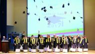 Students of the 11th graduating class of Awsaj Academy celebrate by throwing their graduation caps in the air. 