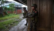 Government troops take position against enemy snipers as they escort rescued workers and trapped residents near the town center where heavy fighting between troops and Muslim militants have been raging in Marawi, in southern island of Mindanao on June 1, 